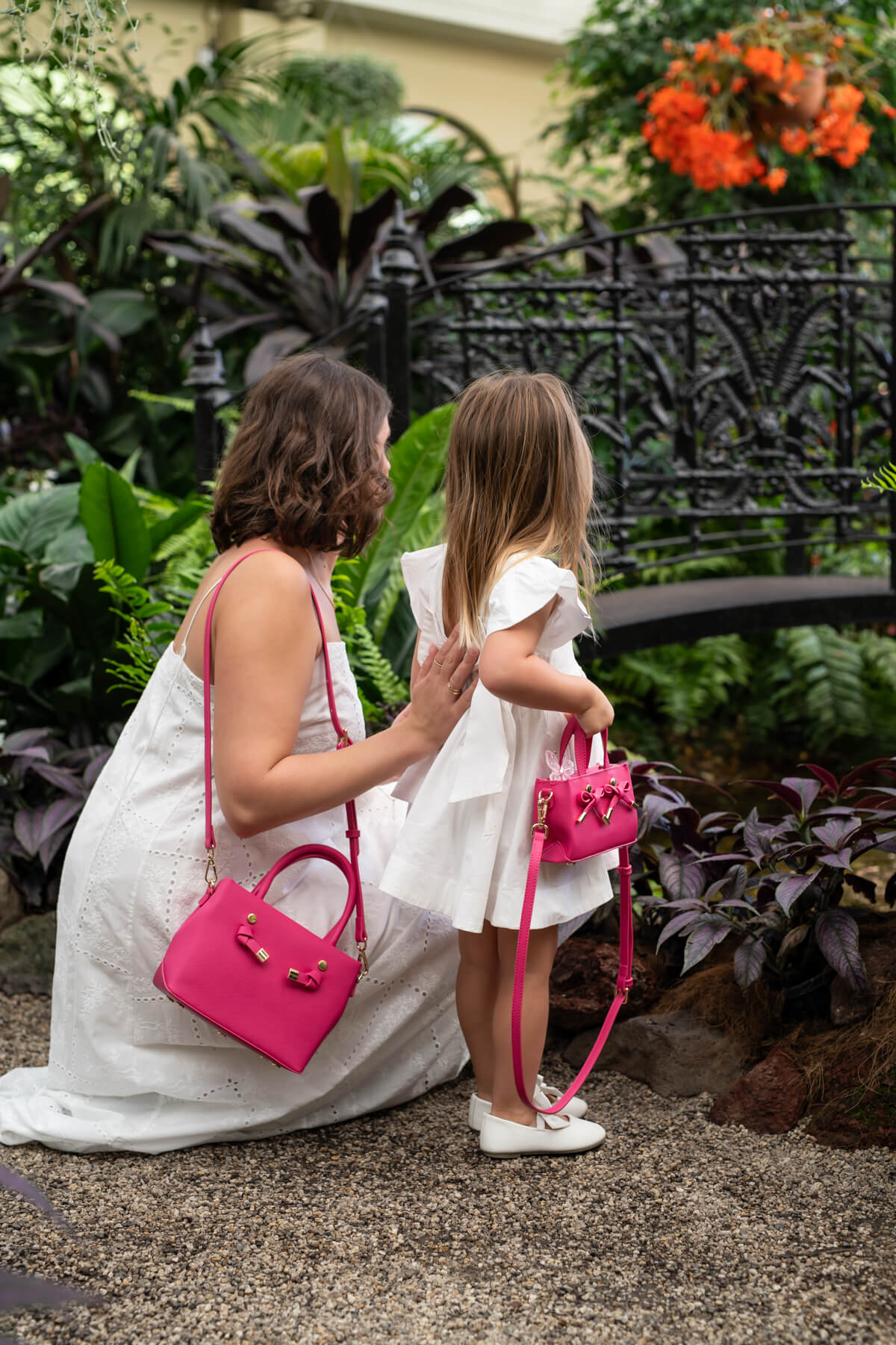 Mother and daughter moment in garden, matching handbags, Edwina Clare pink handbag showcasing texture in product lifestyle photography by Sarah Eliza Images Melbourne Australia