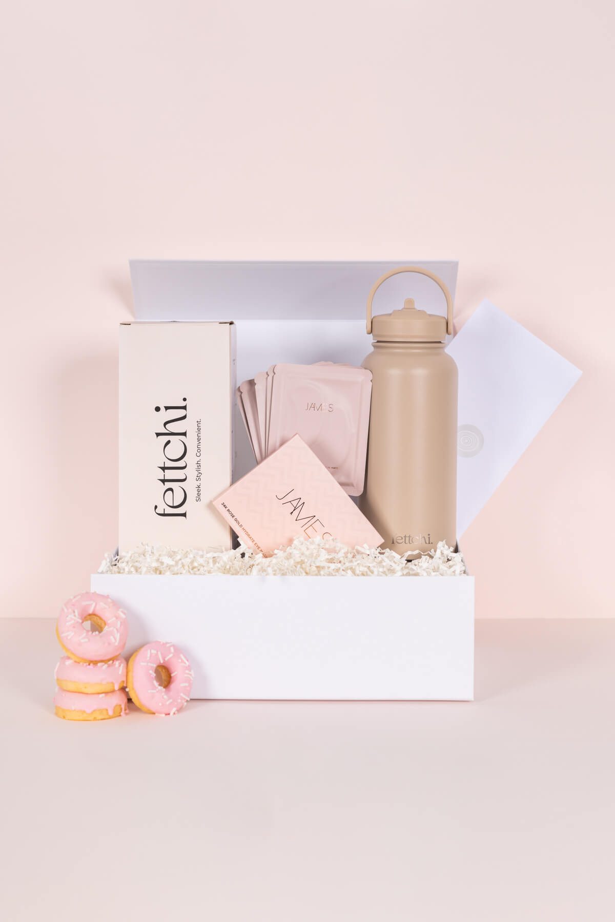 Styled Melbourne product photography of Fettchi Me Time Mother’s Day kit with beige drink bottle, donuts and skincare gift set